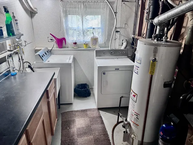 a utility room with sink dryer and washer