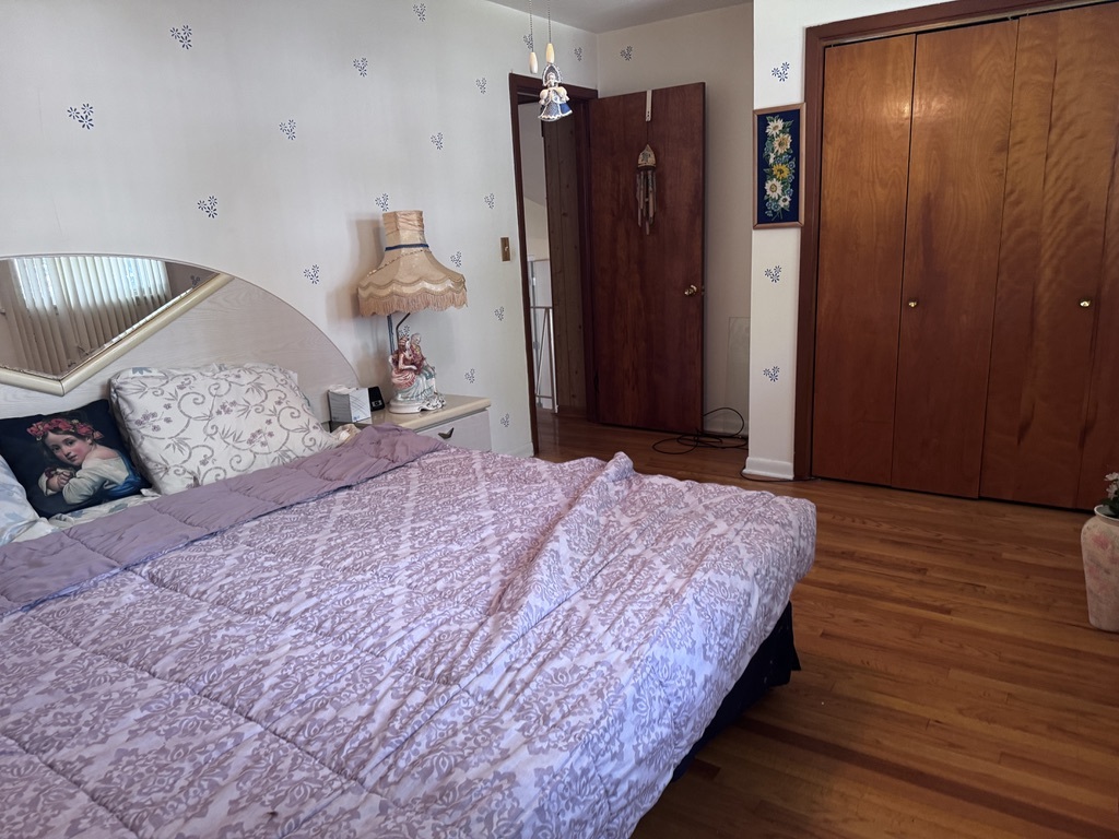 597 Lowden Avenue Glen Ellyn, IL 60137 - Photo 7 of 15 a bedroom with a bed and a chandelier