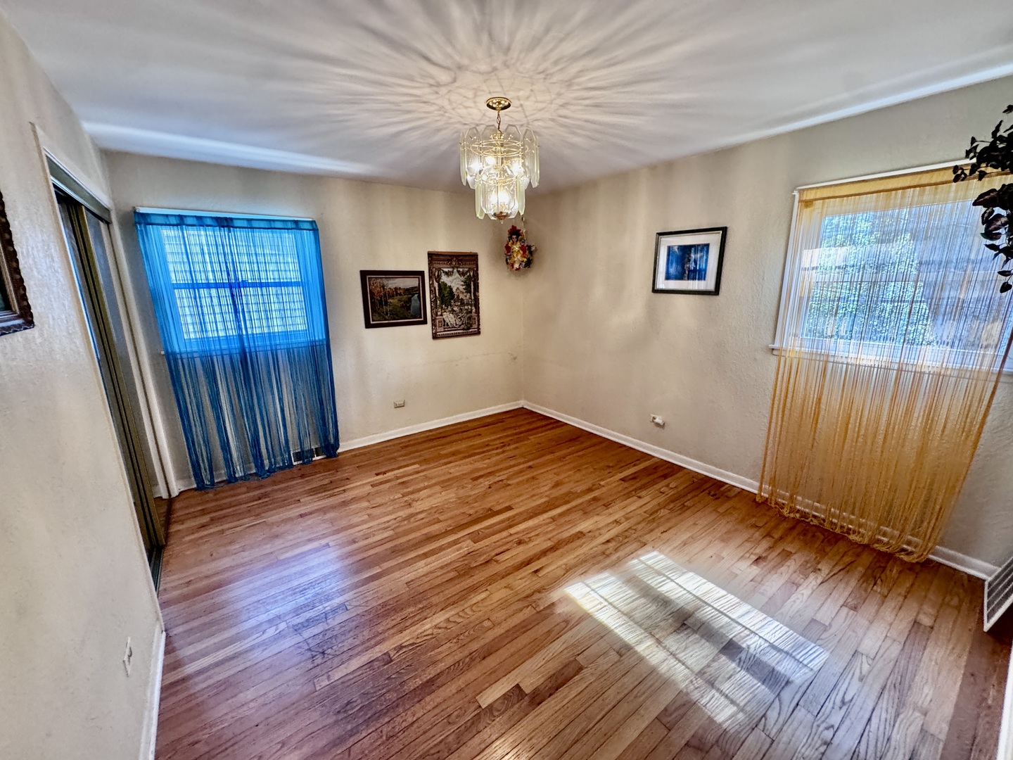 597 Lowden Avenue Glen Ellyn, IL 60137 - Photo 8 of 15 wooden floor in an empty room with a window