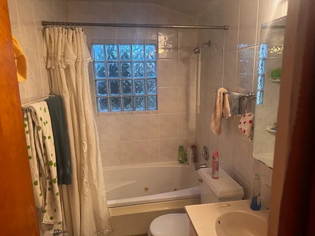 a bathroom with a shower curtain and a bathtub