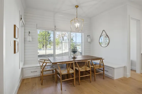 a view of a dining room with furniture window and wooden floor