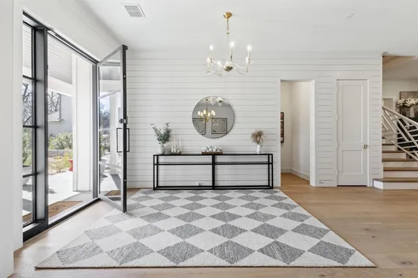 a view of entryway with wooden floor and door
