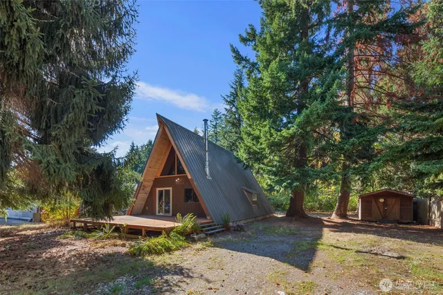 a wooden bench sitting in front of a house