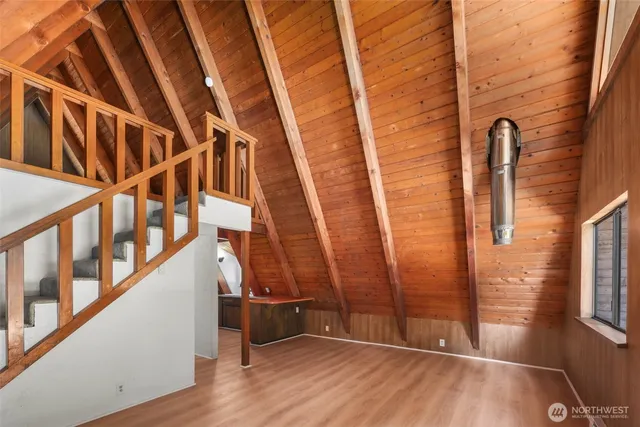 a view of an entryway with wooden floor and door