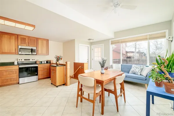 a large kitchen with a table and chairs