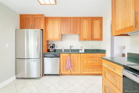 a kitchen with stainless steel appliances granite countertop a refrigerator sink and cabinets