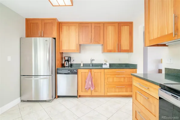 a kitchen with stainless steel appliances granite countertop a refrigerator sink and cabinets