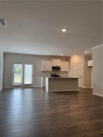 a view of kitchen with microwave and cabinets