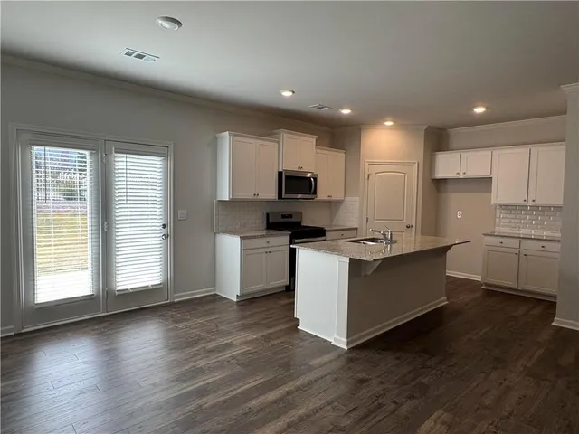 a kitchen with a microwave a stove a sink and a microwave