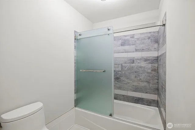 a bathroom with a shower and a toilet