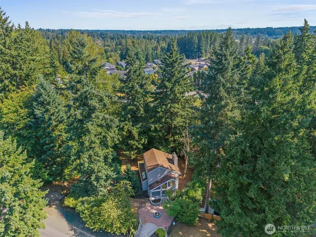 an aerial view of a house with a yard
