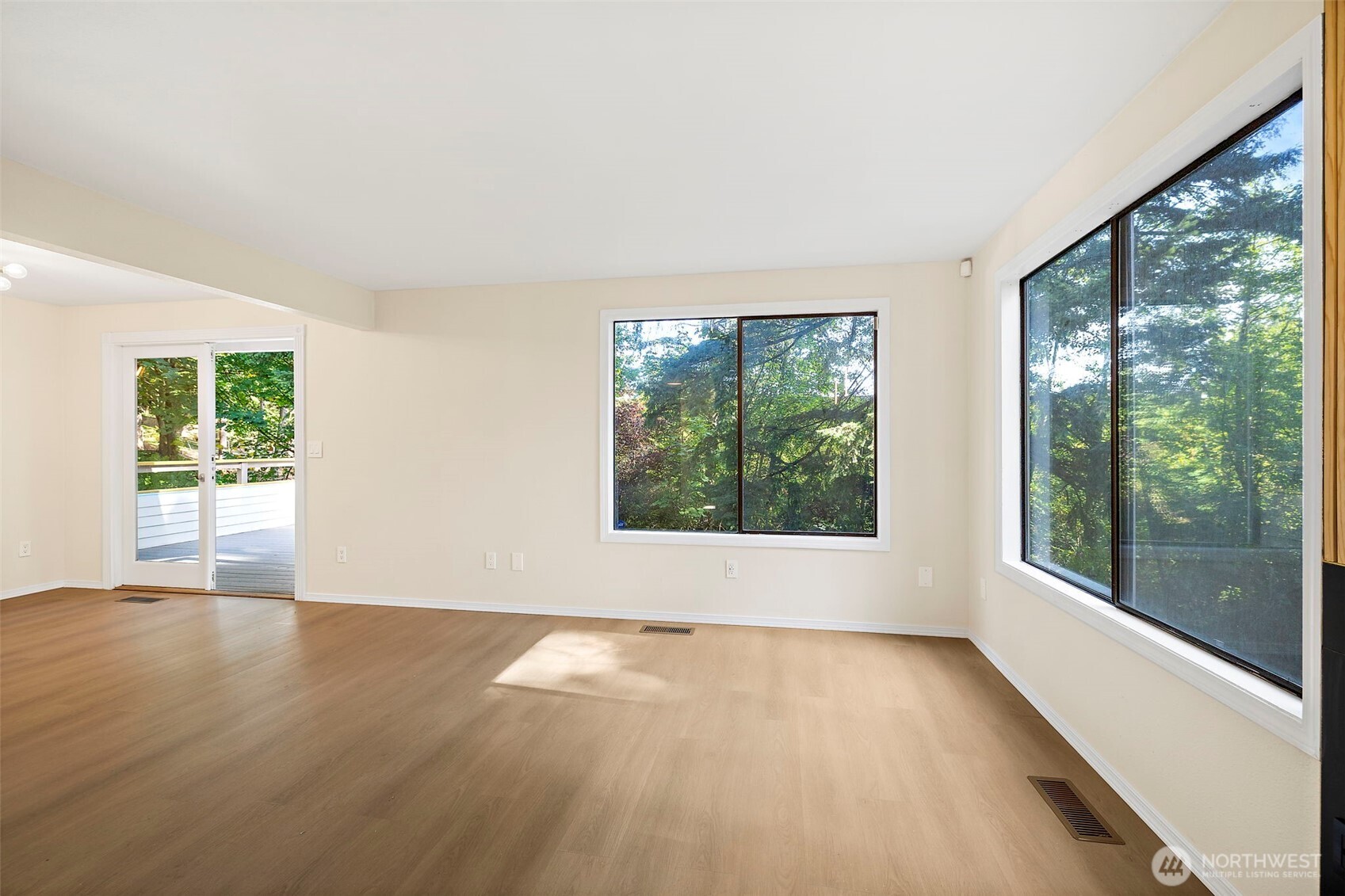 21911 4th Avenue Southeast Bothell, WA 98021 - Photo 7 of 28 an empty room with wooden floor and windows