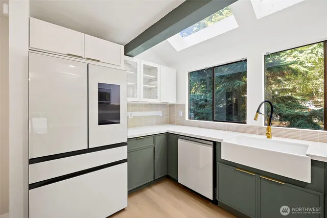 a kitchen with a sink and white cabinets