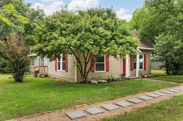 a front view of a house with a garden