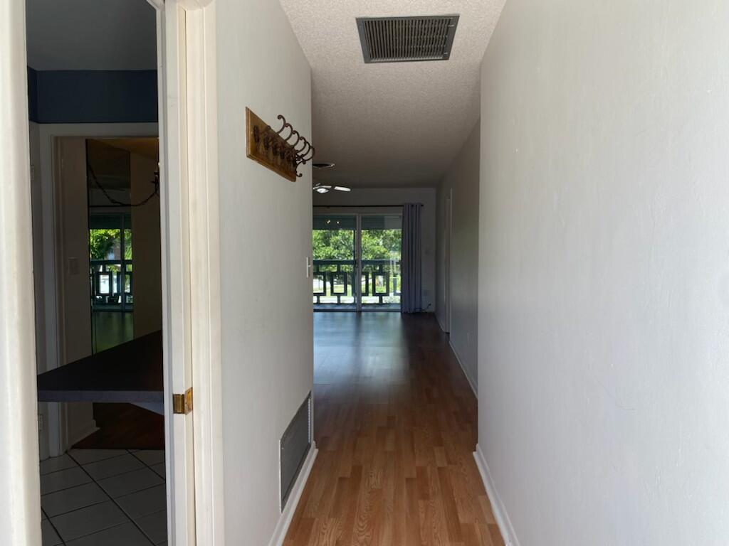 91 Willow Road, Unit 203 Tequesta, FL 33469 - Photo 2 of 9 a view of hallway with wooden floor