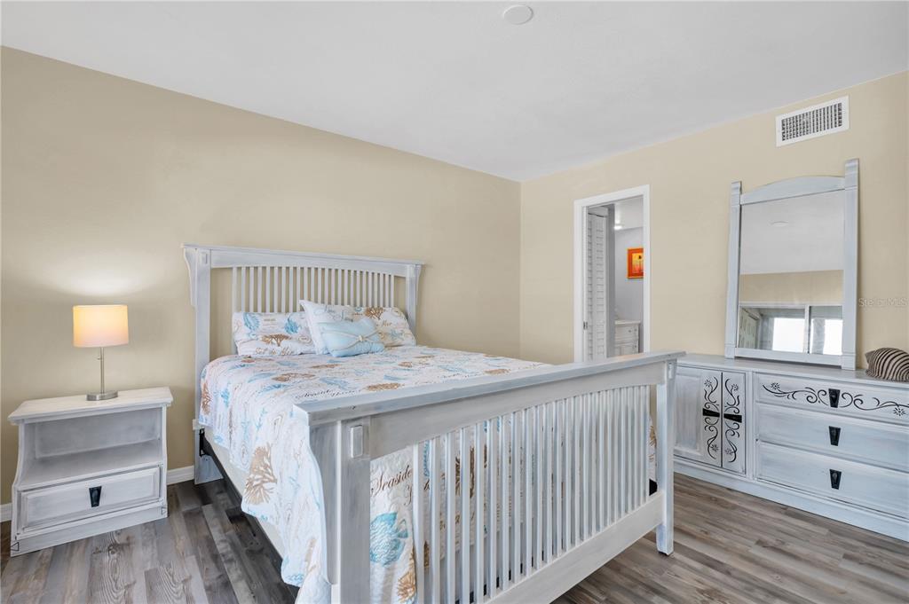 403 Gulf Way, Unit 302 St. Pete Beach, FL 33706 - Photo 12 of 30 a bedroom with a bed and a window