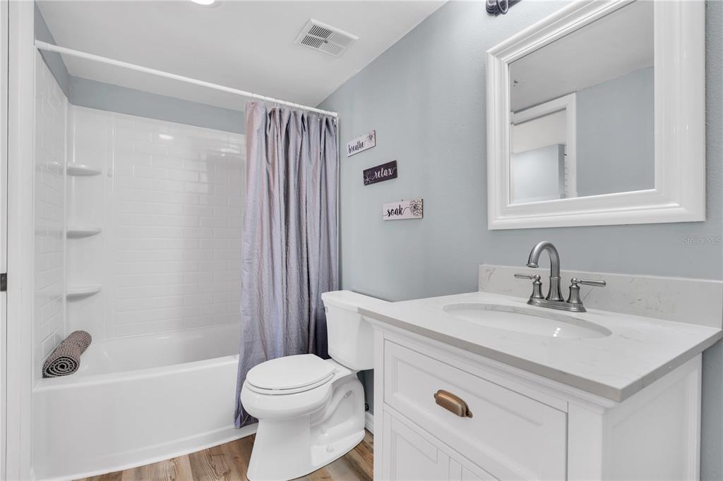 403 Gulf Way, Unit 302 St. Pete Beach, FL 33706 - Photo 15 of 30 a bathroom with a sink toilet and shower