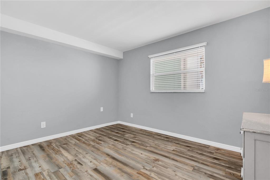 403 Gulf Way, Unit 302 St. Pete Beach, FL 33706 - Photo 16 of 30 a view of an empty room with wooden floor and a window