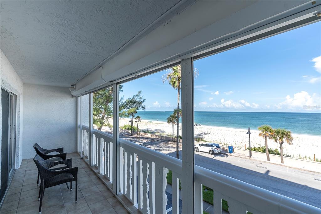 403 Gulf Way, Unit 302 St. Pete Beach, FL 33706 - Photo 2 of 30 a view of a room with wooden floor and outdoor seating