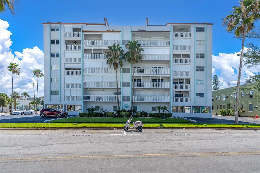 403 Gulf Way, Unit 302 St. Pete Beach, FL 33706 - Photo 30 of 30 a view of a tall building next to a road with a building in the background