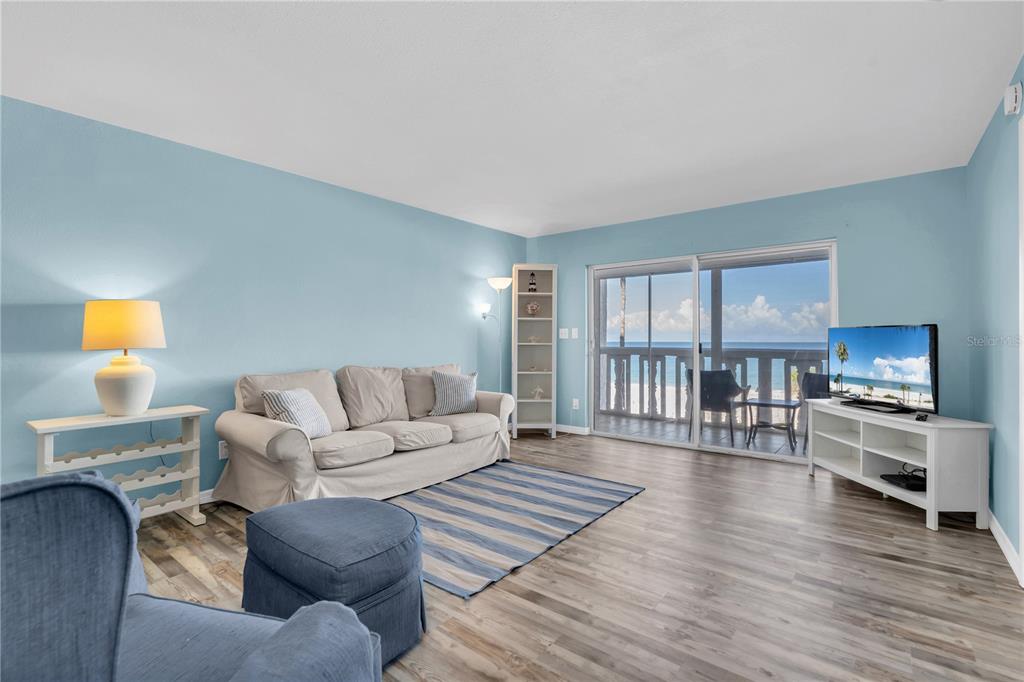 403 Gulf Way, Unit 302 St. Pete Beach, FL 33706 - Photo 4 of 30 a living room with furniture and a wooden floor