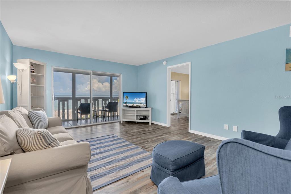 403 Gulf Way, Unit 302 St. Pete Beach, FL 33706 - Photo 5 of 30 a living room with furniture and a large window
