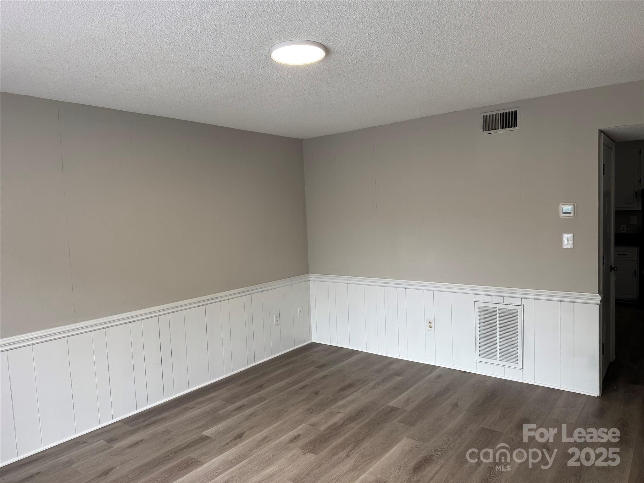 296 Hamilton Drive Northeast, Unit 9 Concord, NC 28025 - Photo 3 of 10 a view of an empty room with wooden floor
