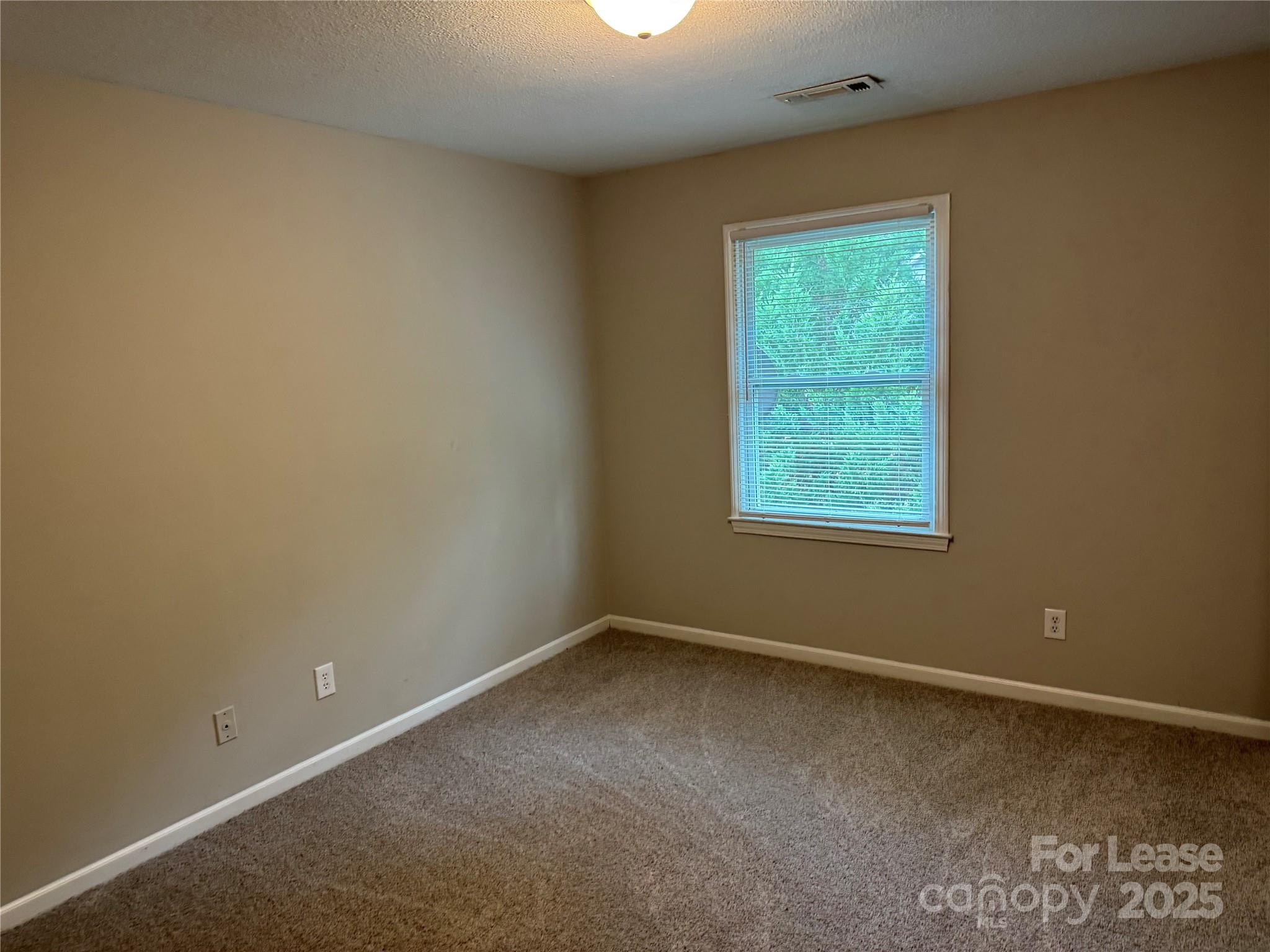 296 Hamilton Drive Northeast, Unit 9 Concord, NC 28025 - Photo 9 of 10 an empty room with a window