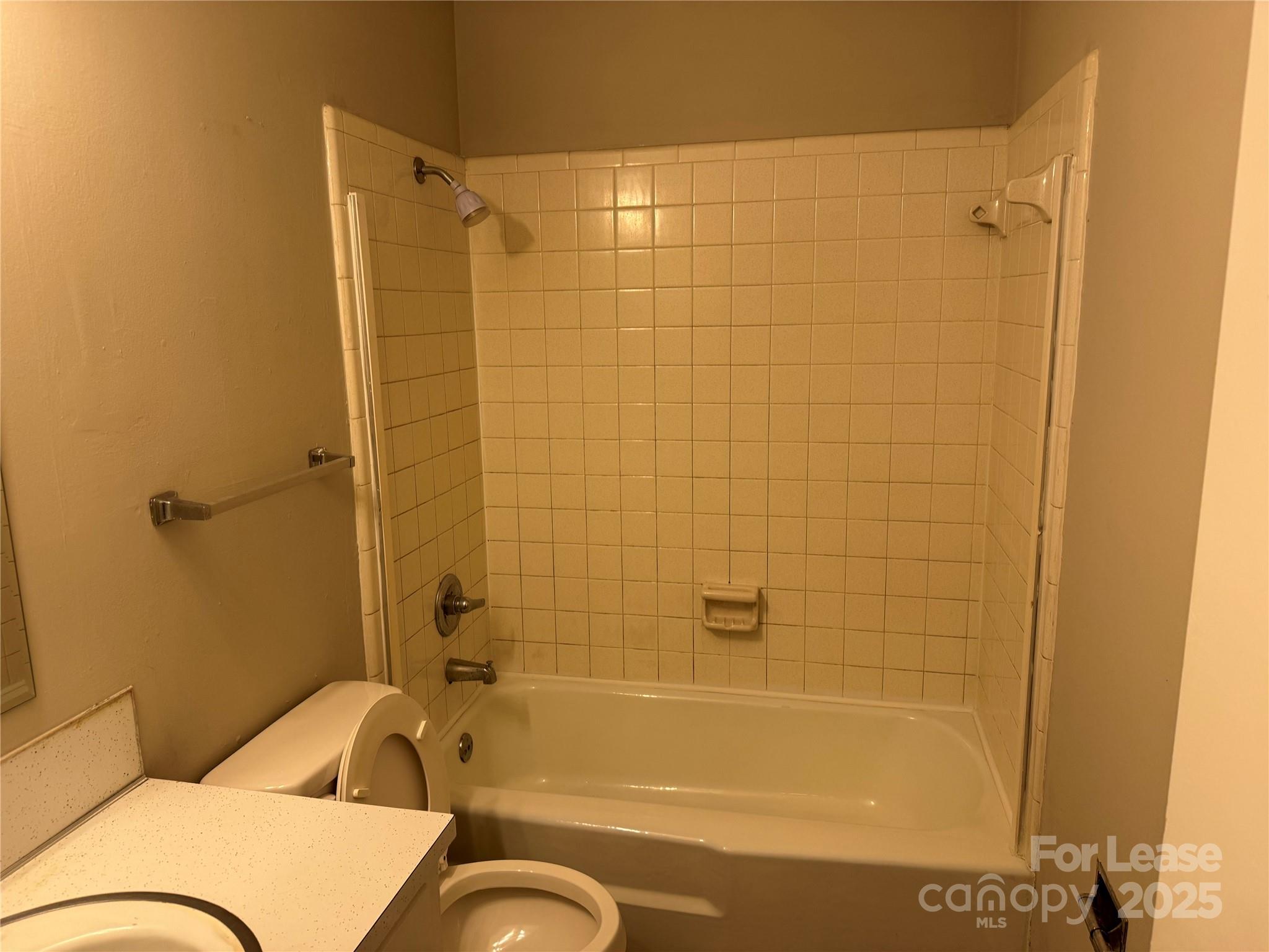 296 Hamilton Drive Northeast, Unit 9 Concord, NC 28025 - Photo 10 of 10 a bathroom with a tub shower sink and a toilet