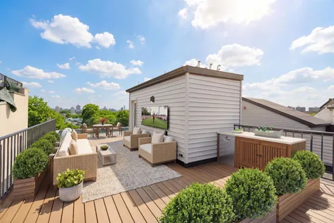 a view of a patio with couches chairs potted plants and sky view