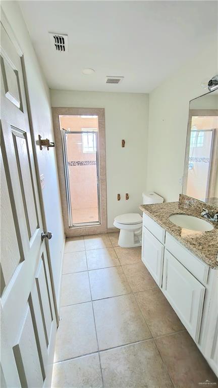 1500 Humming Bird Court, Unit 22 Pharr, TX 78577 - Photo 13 of 15 a bathroom with a granite countertop sink toilet and shower