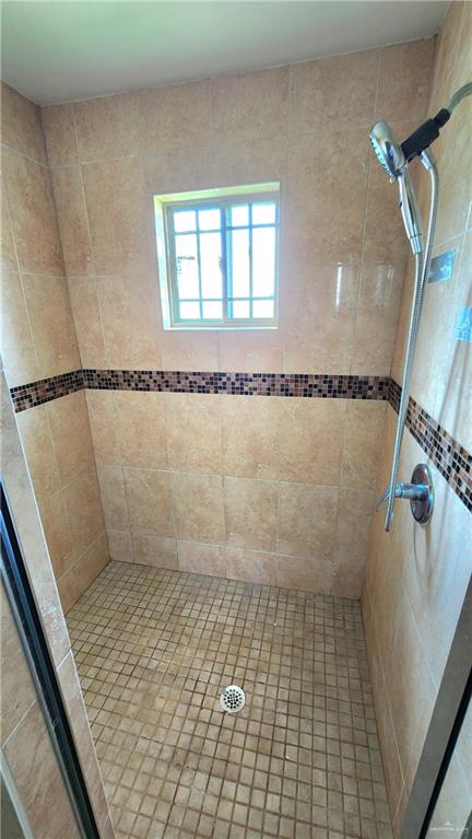 1500 Humming Bird Court, Unit 22 Pharr, TX 78577 - Photo 14 of 15 a bathroom with a glass shower door