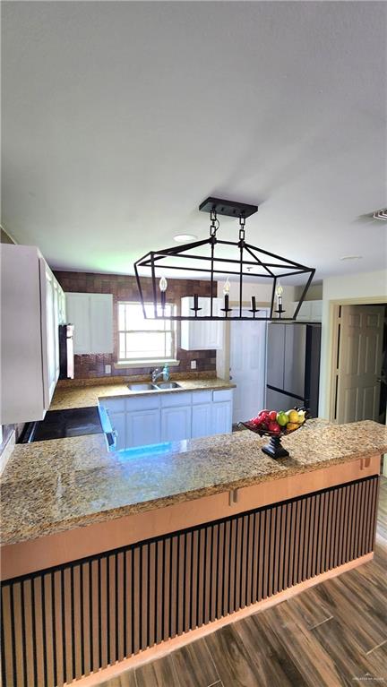 1500 Humming Bird Court, Unit 22 Pharr, TX 78577 - Photo 6 of 15 a bedroom with a bed and wooden floor