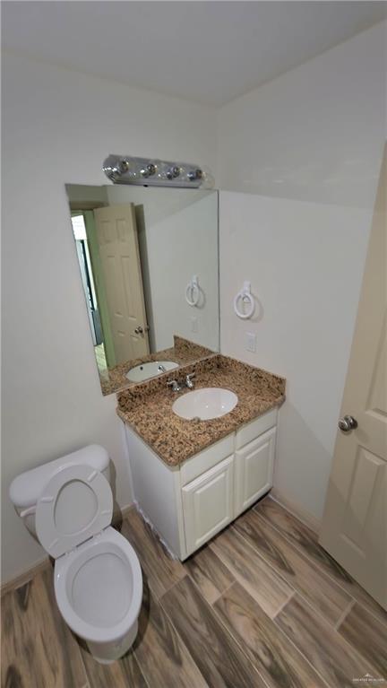 1500 Humming Bird Court, Unit 22 Pharr, TX 78577 - Photo 8 of 15 a bathroom with a granite countertop toilet sink and mirror