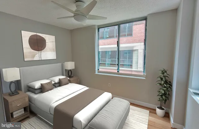 a bedroom with a bed and a potted plant