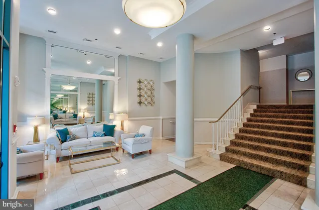 a living room with furniture and a chandelier
