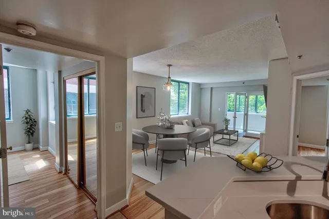 a living room with furniture a window and a rug