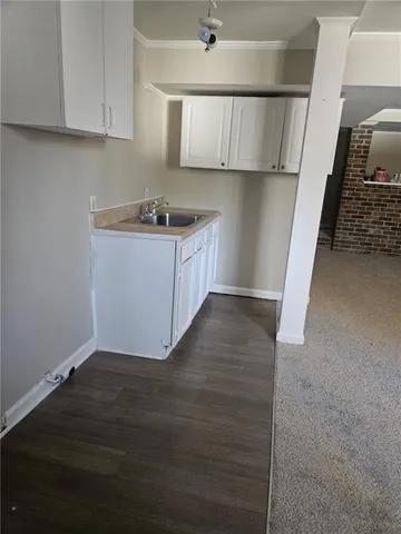 a view of a room with wooden floor