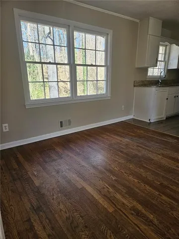 wooden floor in an empty room with a window