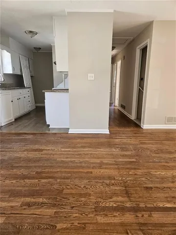 a view of a kitchen with wooden floor