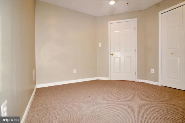 a view of an empty room with window and a projector