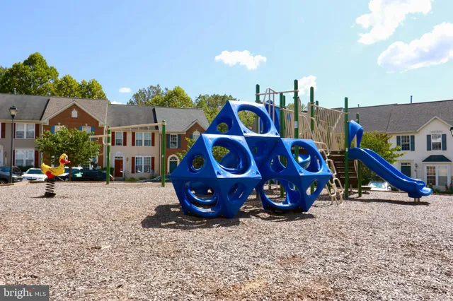 a view of outdoor space with garden and tree