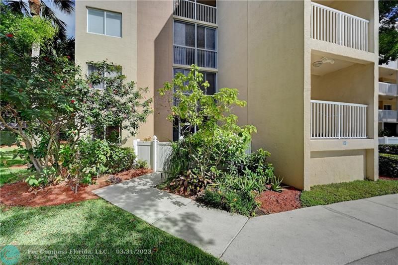 9599 Weldon Circle, Unit A101 Tamarac, FL 33321 - Photo 2 of 28 front view of a house
