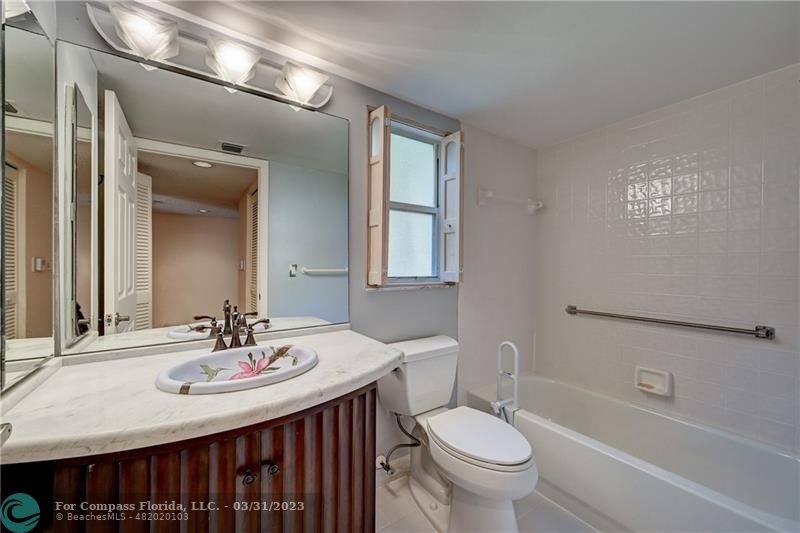9599 Weldon Circle, Unit A101 Tamarac, FL 33321 - Photo 9 of 28 a bathroom with a sink and a mirror