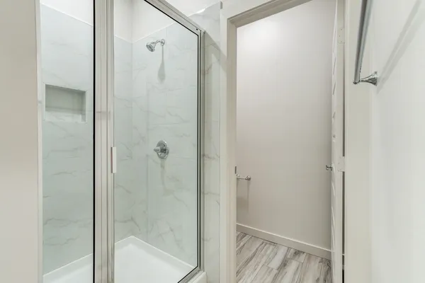 a bathroom with a glass shower door