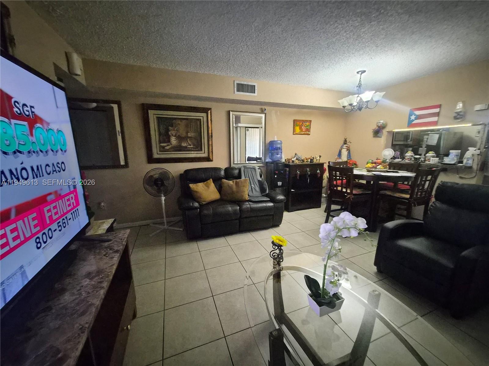 800 Independence Drive, Unit 800F Homestead, FL 33034 - Photo 14 of 26 a living room with furniture and a chandelier