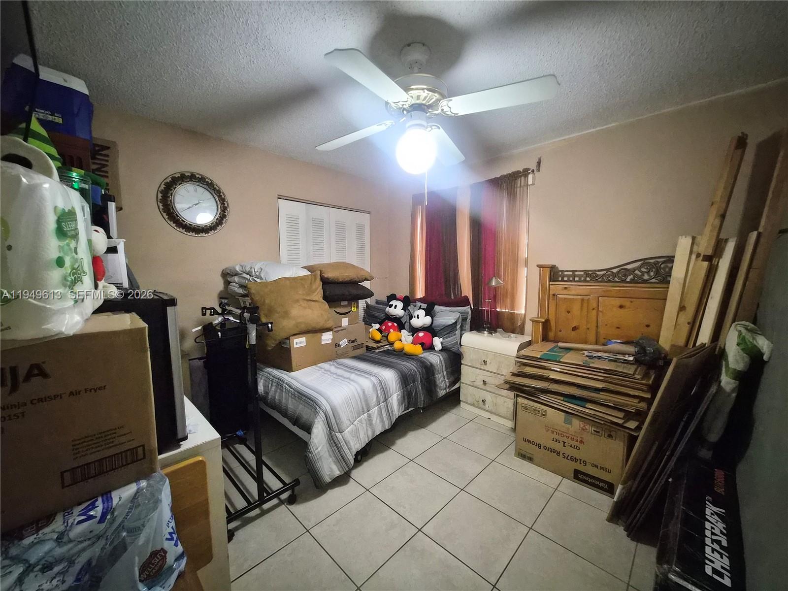 800 Independence Drive, Unit 800F Homestead, FL 33034 - Photo 15 of 26 a bedroom with furniture and a chandelier