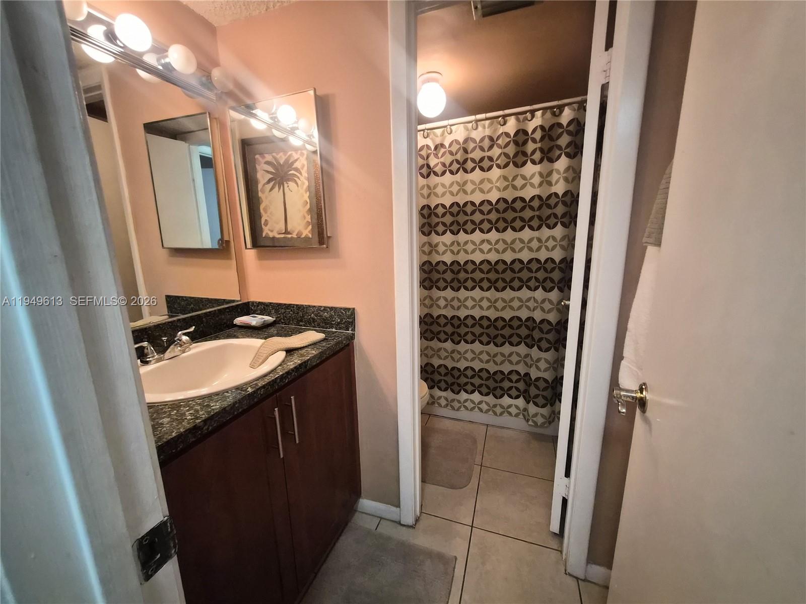 800 Independence Drive, Unit 800F Homestead, FL 33034 - Photo 16 of 26 a bathroom with a granite countertop sink and a shower