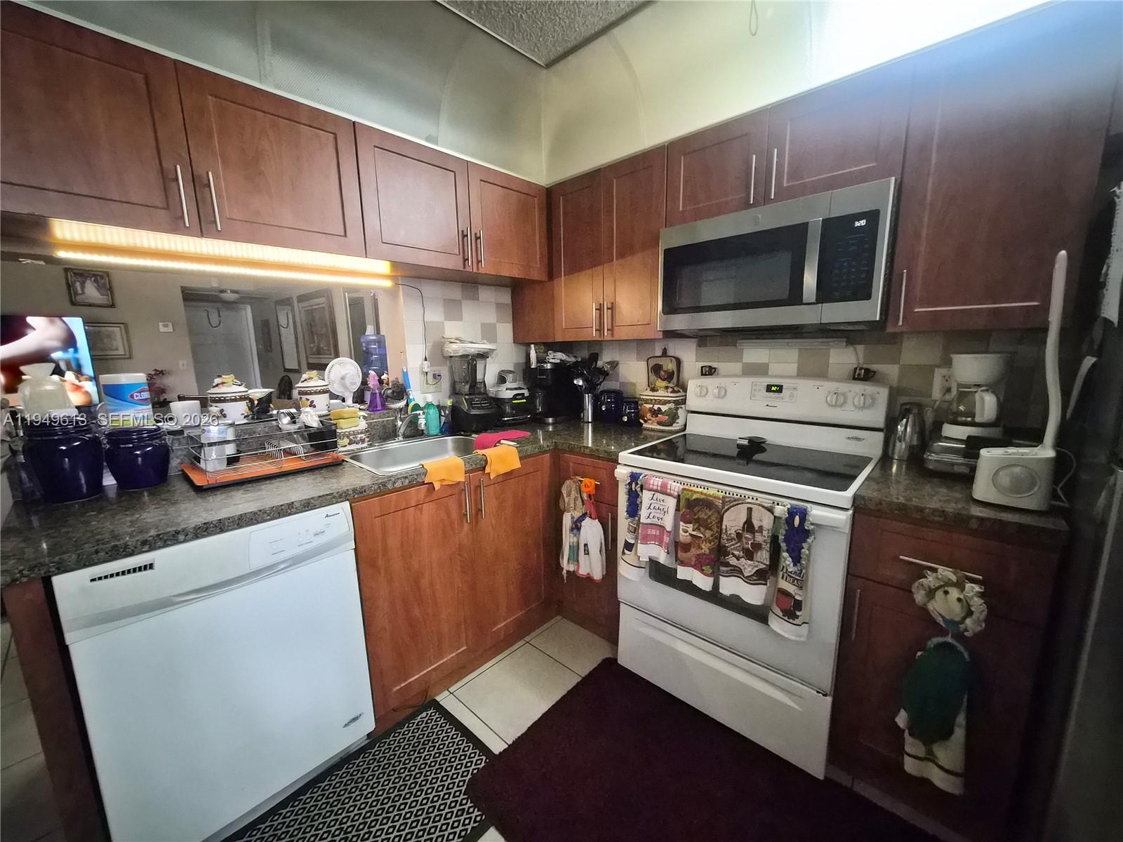 800 Independence Drive, Unit 800F Homestead, FL 33034 - Photo 6 of 26 a kitchen with appliances a counter space and cabinets