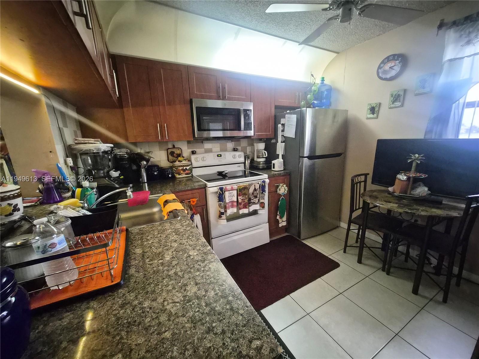 800 Independence Drive, Unit 800F Homestead, FL 33034 - Photo 7 of 26 a kitchen with refrigerator and utility